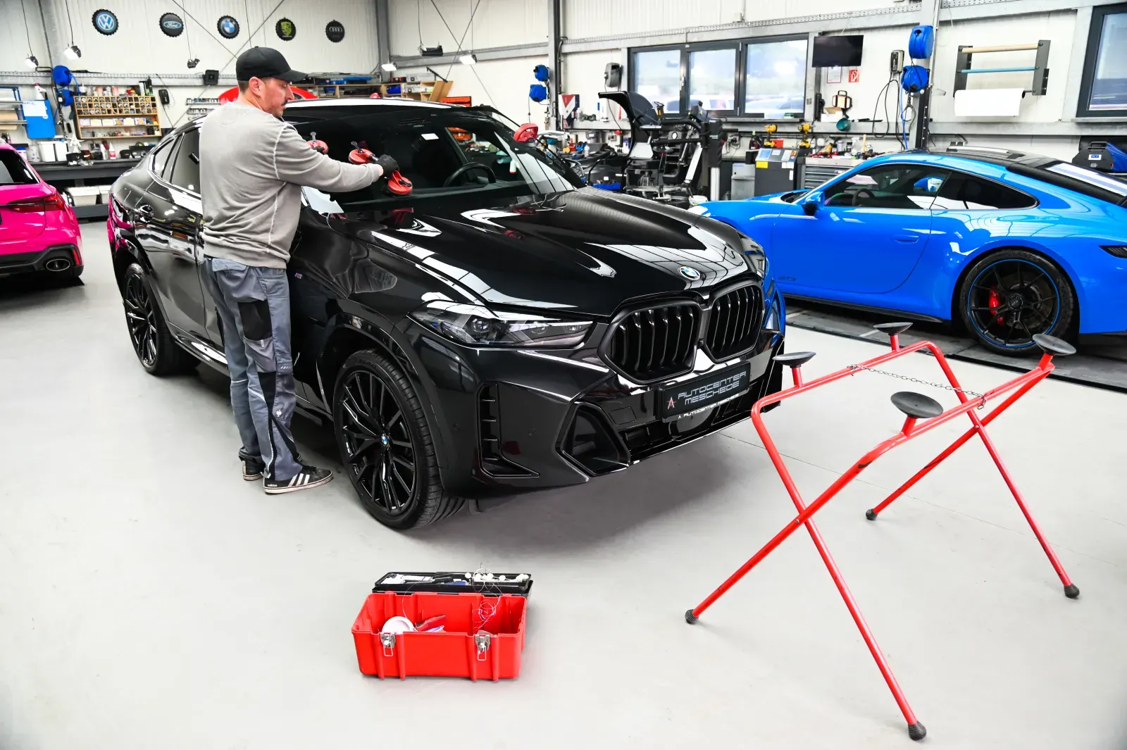 Professional windshield replacement on a sports car